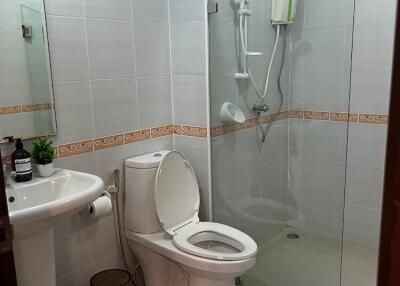 Modern bathroom with glass-enclosed shower and white fixtures