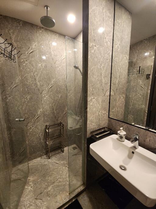 Modern bathroom with glass shower and marble tiles