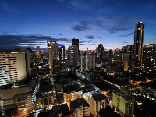 Night view of city skyline with tall buildings and lights