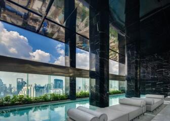 Luxury indoor pool area with skyline view