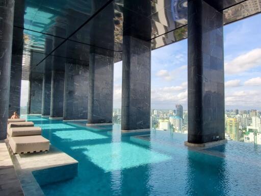 High-rise building with an infinity pool and city view