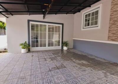 Covered outdoor patio area with tiled flooring