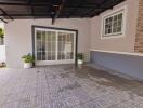 Covered outdoor patio area with tiled flooring