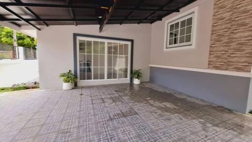 Covered outdoor patio area with tiled flooring