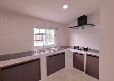 Modern kitchen with large window and built-in appliances