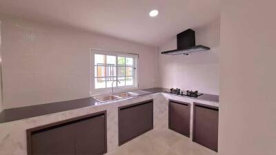 Modern kitchen with large window and built-in appliances