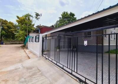 photo of a building exterior with a gated driveway