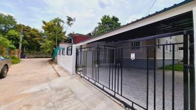 photo of a building exterior with a gated driveway