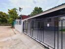 photo of a building exterior with a gated driveway