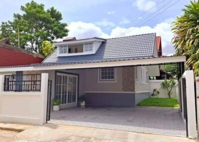 Front view of a modern single-family house with a carport