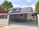 Front view of a modern single-family house with a carport