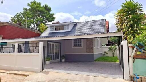 Front view of a modern single-family house with a carport