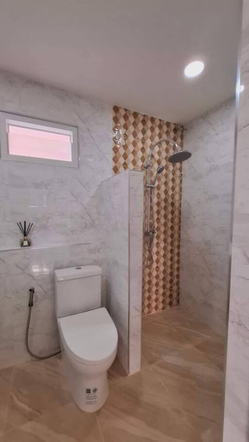 modern bathroom with a standing shower and toilet