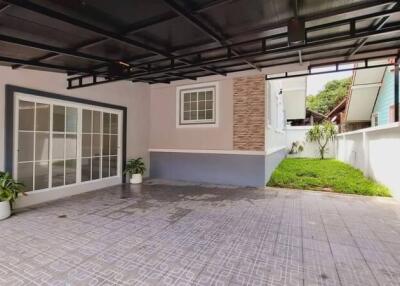 Spacious garage area with tiled flooring and attached garden