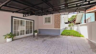 Spacious garage area with tiled flooring and attached garden