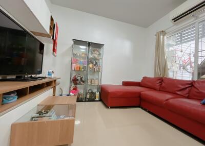 Modern living room with red sofa and glass display cabinet