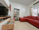 Modern living room with red sofa and glass display cabinet