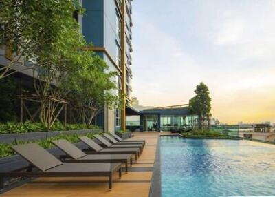 Outdoor swimming pool area with lounge chairs