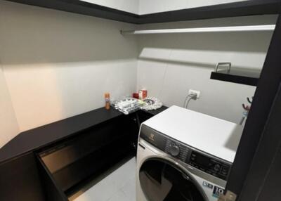 Utility room with washing machine and storage