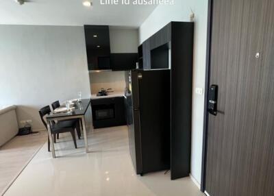 Modern kitchen and dining area with fridge and table