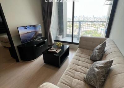 Living room with balcony view, TV, and comfortable sofa