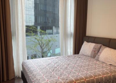 Bedroom with large window and modern decor