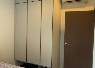 Bedroom with wardrobe and air conditioning unit