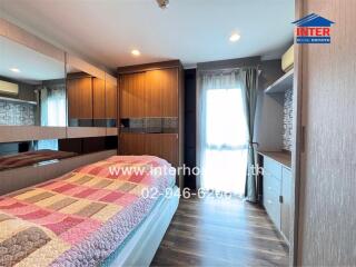 Spacious bedroom with modern furniture and ample natural light