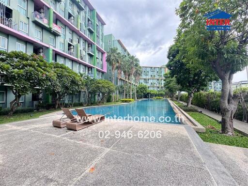 Outdoor view of residential building with a swimming pool and landscaped surroundings