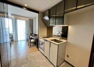 Modern kitchen with dining area and open view into the bedroom