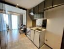 Modern kitchen with dining area and open view into the bedroom