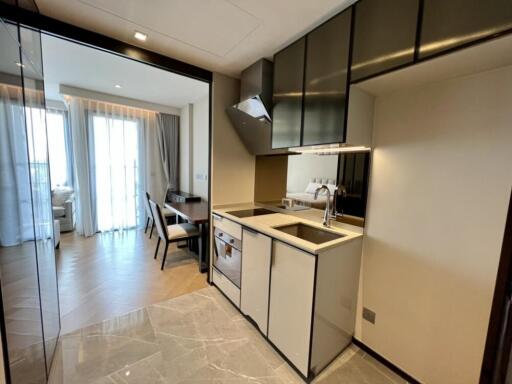 Modern kitchen with dining area and open view into the bedroom