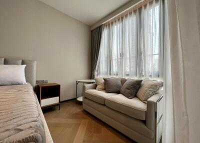 Cozy bedroom with bed and sofa near a large window