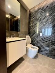 Modern bathroom with sleek design and dark marble walls