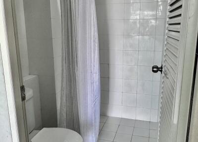 A clean and simple bathroom with a shower and curtain.