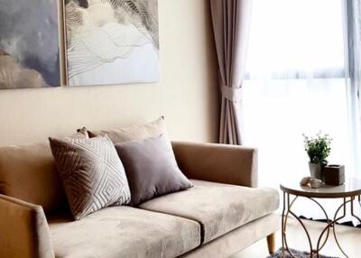 Modern living room with a beige sofa and artwork