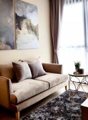 Modern living room with a beige sofa and artwork