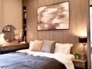 Modern bedroom with wall art, bedside tables, and lamps