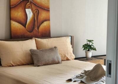 Cozy bedroom with bed and wall art