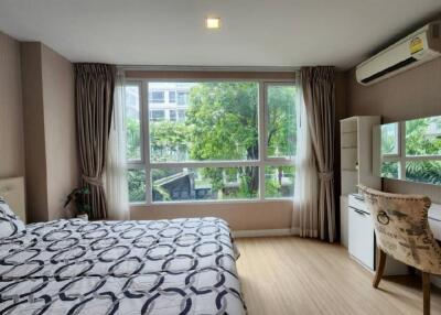 Modern bedroom with large windows and natural light