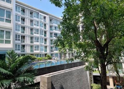 Modern apartment complex with pool and greenery