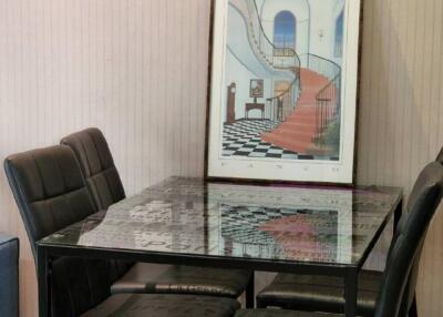 Dining area with glass table and modern chairs