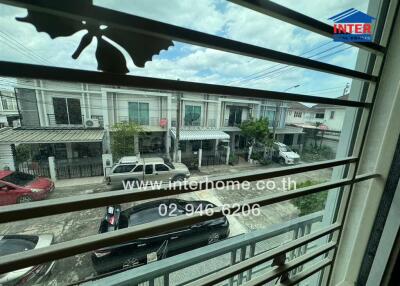 View from window showing street and residential buildings