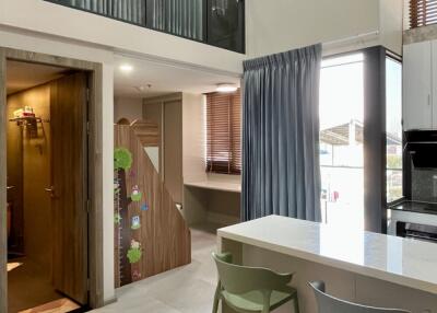 Modern kitchen with breakfast bar and loft-style upper level