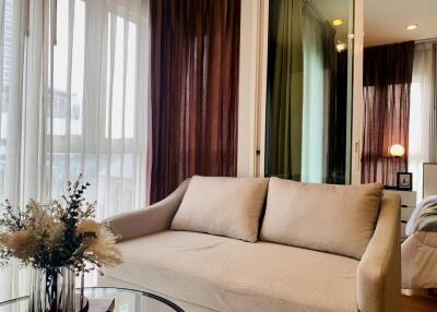 Cozy living room with a beige sofa and a glass coffee table