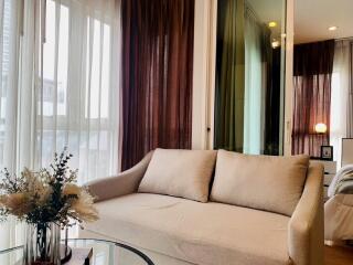 Cozy living room with a beige sofa and a glass coffee table