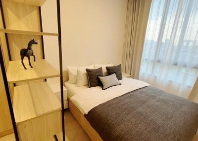 Modern bedroom with decorative shelves and a neatly made bed