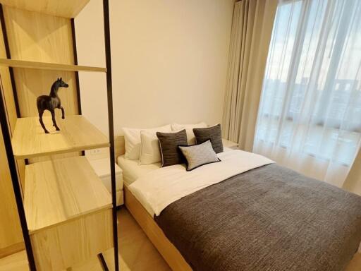 Modern bedroom with decorative shelves and a neatly made bed