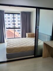 Bedroom with large windows and a comfortable bed