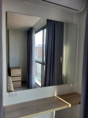 Bedroom with window and mirror